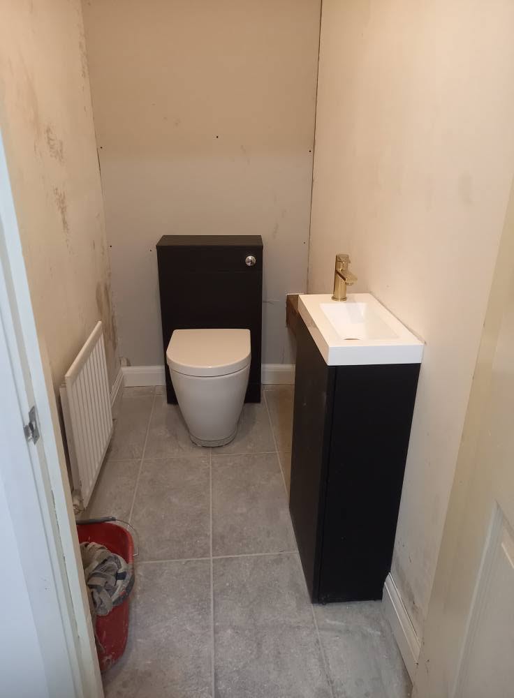 Compact cloakroom refurbishment with modern toilet and basin